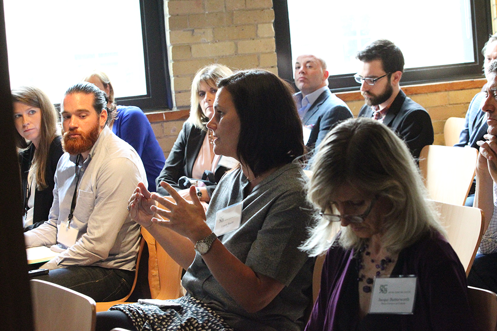 Posing questions to the panel during the Q&A period