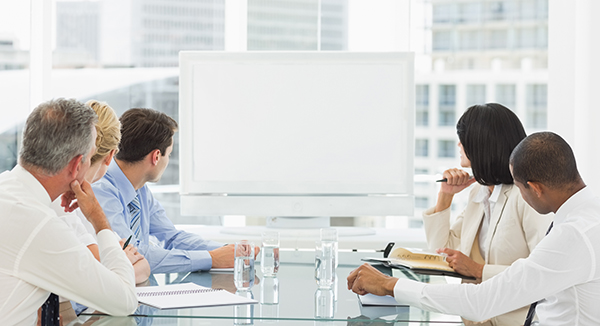 Business people looking at blank whiteboard in the office